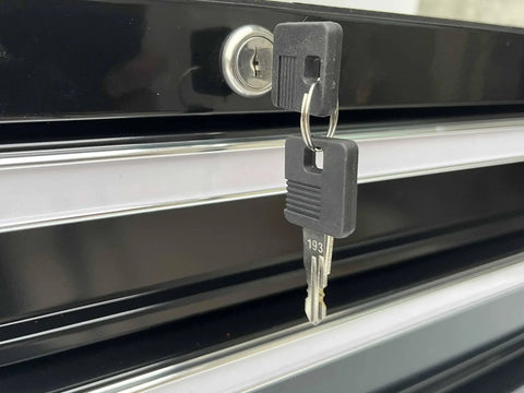 Close-up of the central cam lock with keys on the Beefy Two Drawer Portable Metal Tool Chest Cabinet With Ball Bearing Drawer Slides And 26 Inch Steel Storage Box Organizer Non Slip Drawer Liners Black.