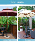 All Weather Granite Outdoor Umbrella Stand Tube Universal Base supporting umbrellas on a wooden deck in an outdoor park and courtyard.