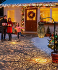Family enjoying holiday evening with garden lit up, showcasing solar lanterns casting patterns on snow.