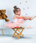 Child sitting on Foldable Shower Stool For Tiny Bathrooms Bamboo Foot Rest And Shaving Stool Space Saver Portable Folding Shower Bench
