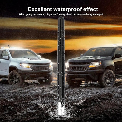 7 Inch Short Antenna With Dope American Flag Vibe And Tire Valve Caps against a rainy backdrop with trucks