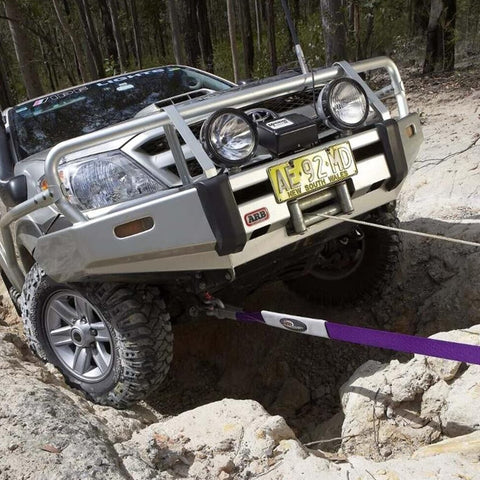 SUV using Beefy Winch Extension Strap For Tough Recovery 9900 Lbs Breaking Strength in off-road situation, 66 ft long, 3 in wide