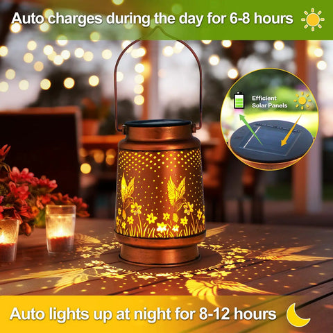 Outdoor Solar Lantern With Hummingbird Pattern on table surrounded by lit candles, bronze finish, 6.7x4.7 inches, cozy evening vibe