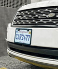 2-Pack Matte Black License Plate Frames, Rust-Proof Aluminum 12.25 x 6.25 Inch, 2-Hole Mount on white car front plate.