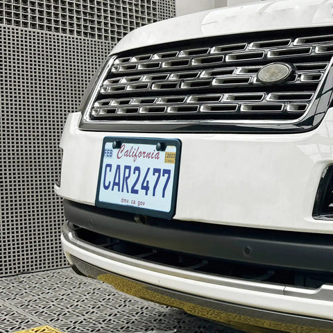2-Pack Matte Black License Plate Frames, Rust-Proof Aluminum 12.25 x 6.25 Inch, 2-Hole Mount on white car front plate.