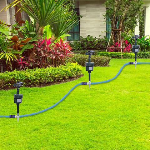 Rock Solid Motion Activated Yard Sprinkler With Adjustable 360 Spray Head in a lush green garden, featuring water hose setup.