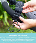 Hand attaching Stroller Hooks 2 Pack Carabiner Clips For Baby Gear Heavy Duty Universal Stroller Clips to a stroller bar