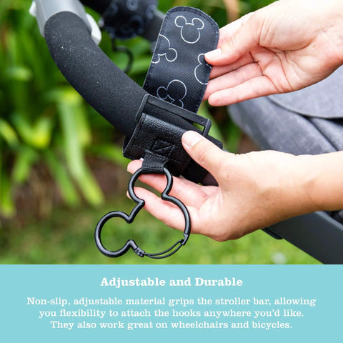 Hand attaching Stroller Hooks 2 Pack Carabiner Clips For Baby Gear Heavy Duty Universal Stroller Clips to a stroller bar