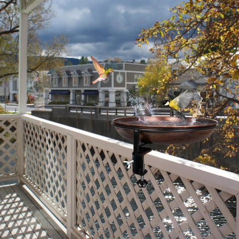 Deck Mounted Metal Bird Bath With Adjustable Steel Clamp For Railings And Balconies, installed on a wooden deck railing with birds using the bowl.