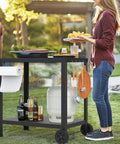 32x20IN Double Shelves Grill Table Movable Outdoor Grill Cart For Griddle And Pizza Oven, woman serving food at a garden party