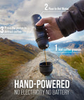 Hand using Minipresso GR Portable Espresso Machine For Ground Coffee, Manual Hand Press Coffee Maker in a mountain setting