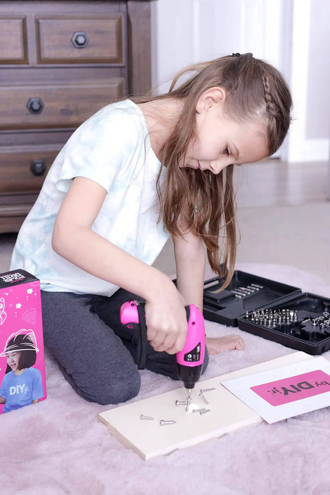 Girl using Girls Power Drill Set With Realistic Drilling Action 60 Piece Tool Kit Rechargeable Cordless Pink Drill With LED Light