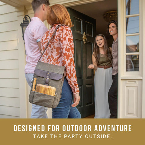 Straight Up Insulated Wine Bag With Matching Cheese Board And Sharp Corkscrew Opener Waxed Canvas Cooler Tote For Two Bottles Pocketed Grab And Go Hauler For Weekend Kickbacks In Khaki Green being carried at a door.