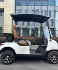 Kick Back In Comfort On This Sleek White Two Seater Electric Golf Cart Powered By A Dependable 48V Lithium Battery All Weather Dash Switches And Sure Grip Tires For Every Epic Course Round side view showing brown seat and controls.