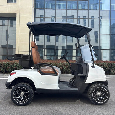 Kick Back In Comfort On This Sleek White Two Seater Electric Golf Cart Powered By A Dependable 48V Lithium Battery All Weather Dash Switches And Sure Grip Tires For Every Epic Course Round side view showing brown seat and controls.
