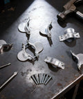 Two Piece Dryer Cord Strain Relief Clamp Kit with screws on workbench for secure electrical connection