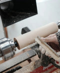 Two Pack One Inch And Three Quarter Inch Multitooth Drive Centers With Spring Loaded Point For Wood Lathe Chuck Fits Most Four Jaw Chucks In Wood Turning Lathe No Hassle Center Changes in use on a wood lathe with wood piece being shaped by hand.