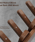 Close-up of Walnut Wood Coat Rack Wall Mount with retractable hangers showing strong magnetic hold on a gray background.