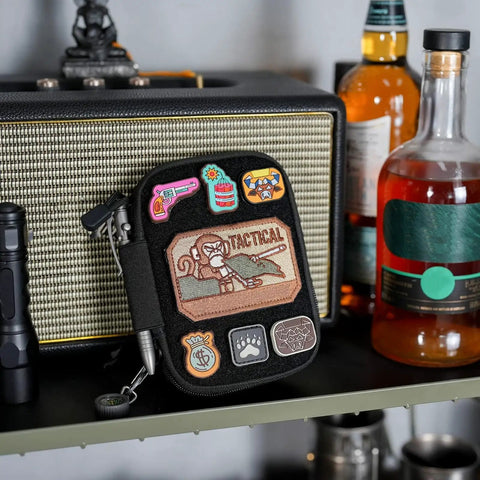 EDC Pocket Organizer Pouch With DIY Patches Area nylon utility pocket on shelf with colorful patches and tactical motif.