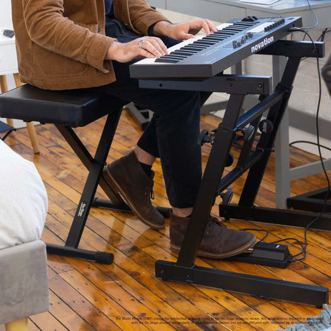 Heavy Duty Folding Z Keyboard Stand With Adjustable Height From 23.5 To 36.5 Inches in use with keyboard and musician