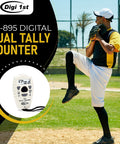 Slick Dual Display Electronic Tally Counter With Quick Add Subtract Thumb Clicker Design Killer For Golf Pitches Lap Timing And Weekend Sports Rallies shown with a pitcher in action at a baseball field.