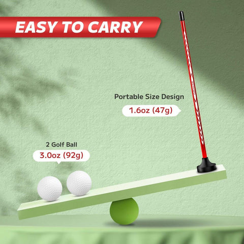 Red magnetic golf alignment rod and two golf balls displayed on a balance scale highlighting portable design and weight.