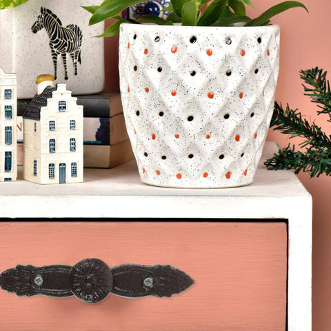Pink drawer with vintage cast iron drawer pull, antique dresser handle, classic iron furniture hardware in rustic setting