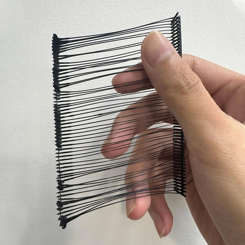 Hand holding a bundle of Premium Heavy Duty Plastic Tagging Fasteners For Retail Apparel Label Guns Hassle Free Price Tag Barbs Bulk Pack Of One Thousand Black Clothing Accessories.