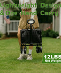 Person carrying a heavy duty foldable wagon cart with all terrain wheels, 220 lb capacity, for beach, garden, groceries, camping.