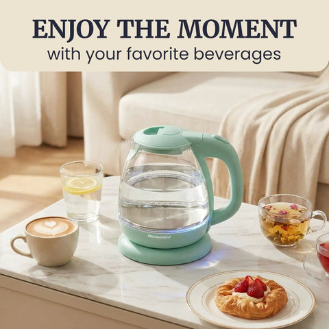 Elite Gourmet Mint Glass Electric Kettle 1L BPA-Free Fast Boil cordless with auto shut off on a marble table.