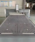Beefy Heavy Duty Tank Grade CNC Wood Router 1325 4x8 for engraving, showing large workbed in an industrial woodshop