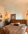 EHFMGYB Rattan Wall Sconces Set of Two Plug in, Boho Wall Lamp with 9.84FT Plug in Cord beside a cozy bed in a stylish bedroom.