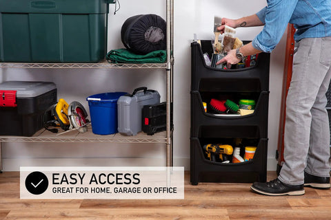 Person using Jumbo Stackable Storage Bins Pack Of 3 With Large Easy Grip Handles And Wide Front Opening For Quick Access Interlocking And Vertical Stacking Heavy Duty Rust And Water Resistant Black in garage