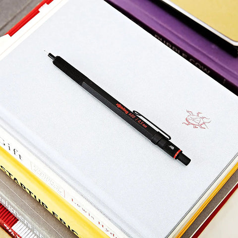 Precision 0.5mm Mechanical Pencil With Full Metal Body And Knurled Grip for writing, shown on a stack of books