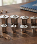 8 lightweight iron pins from 16 Piece Dowel and Tenon Center Transfer Plugs for Woodworking Drill Alignment Tool on a wooden table.