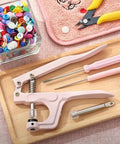 Snap Pliers Set For T3 T5 T8 KAM Snaps Handheld Button Fastener Press Attacher For Crafts Garments And DIY Clothing Projects Easy To Use Includes Sockets Rod And Tool Kit, pink with tools on tray.