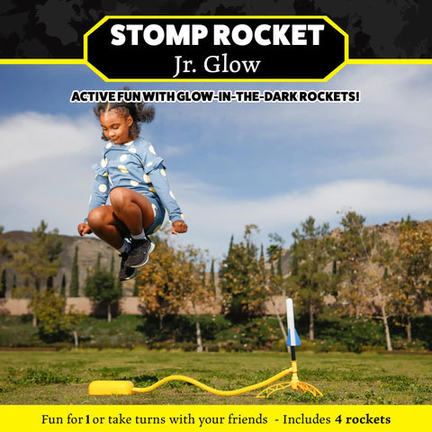 Child jumping to launch Glow In The Dark Rocket Launcher Kit for Kids with Four Soft Foam Rockets, outdoor fun in a park.
