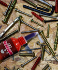 Purple Threadlocker High Strength Oil Resistant Anaerobic Adhesive bottle surrounded by various screws on a workbench