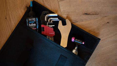 Tool storage pocket showing tools for Flipstand Compact Bike Stand With Tool Storage, Saddle Protector And Handlebar Stabilizers For All Bike Types, Water Repellent Outer And Lightweight Build, The Ride Ready Repair Stand For Weekend Rides And Race Day