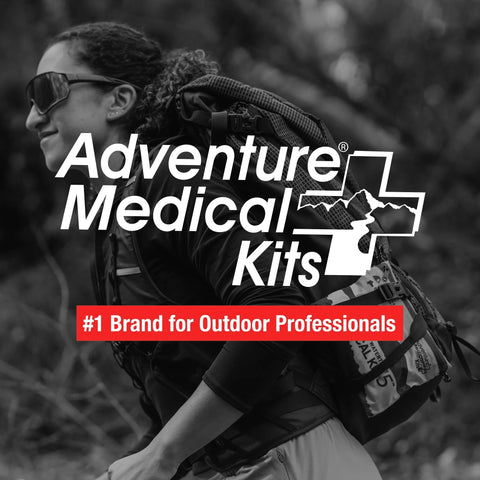 Adventure Medical Kits Ultralight/Watertight Medical Kit logo visible with hiker wearing backpack outdoors