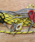 Black and red 6.25 inch carbon steel shears for cutting Kevlar with ropes in background, focus keyword: Six And A Quarter Inch Carbon Steel Shears For Cutting Kevlar Dyneema Spectra Vectran Nomex Technora Zylon Innegra Carbon Fiber Fiberglass And Other High Tensile Materials.