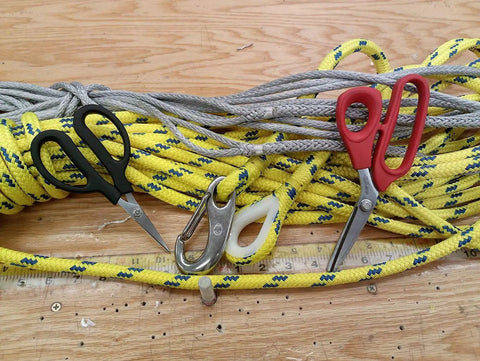 Black and red 6.25 inch carbon steel shears for cutting Kevlar with ropes in background, focus keyword: Six And A Quarter Inch Carbon Steel Shears For Cutting Kevlar Dyneema Spectra Vectran Nomex Technora Zylon Innegra Carbon Fiber Fiberglass And Other High Tensile Materials.