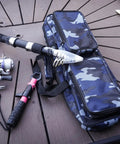 17 Inch Fishing Tackle Carrier Bag With Two Front Pockets Travel Large Capacity Rod Case on wooden deck with fishing gear.