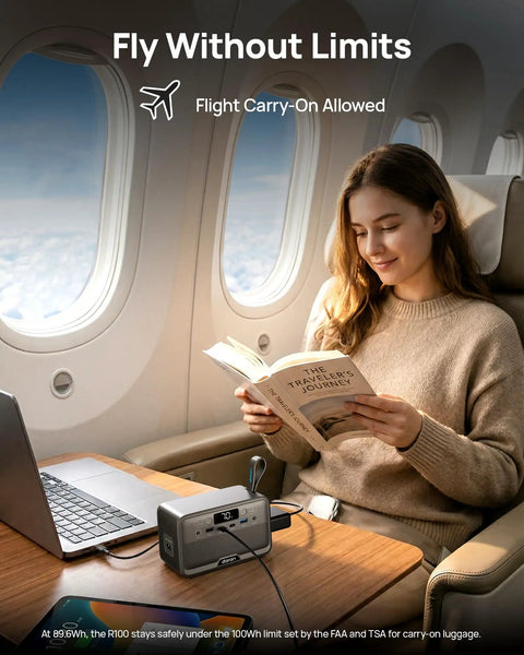 Slick Pocket Sized Portable Power Station With Resilient LiFePO4 Cell And 100 Watt Output on an airplane table, being used while reading.