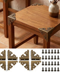 Antique Bronze Metal Corner Protectors Set Of 8 Decorative Brackets for wood furniture with screws shown on wooden table.