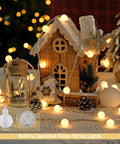 Warm White 100 LED Globe Battery Operated Christmas Lights Indoor With Eight Modes For Cozy Dorm Room Bedroom Or Tree Decor Soft Glow Easy On Battery Perfect For Year Round Holiday Vibes illuminating a wooden house decor