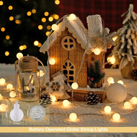 Warm White 100 LED Globe Battery Operated Christmas Lights Indoor With Eight Modes For Cozy Dorm Room Bedroom Or Tree Decor Soft Glow Easy On Battery Perfect For Year Round Holiday Vibes illuminating a wooden house decor