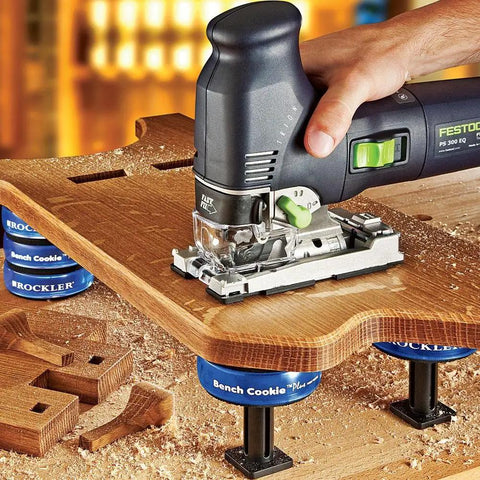 Hand using a router on wood supported by XL Risers For Bench Cookie Plus And Connect Work Grippers, Heavy Duty Woodworking Upgrade For Clearance And Lateral Stability, Height Up To 5 Inches, Wood Riser With Threaded Stud, 4 Pack.