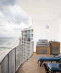 Outdoor 10 Inch Round LED Nautical Bulkhead Light Flush Mount for Wall or Ceiling on balcony with view of beach and ocean