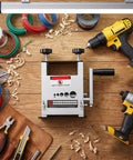 Adjustable Manual Wire Stripper Drill Attachment Tool For Electric Wires And Cables on a wooden workbench with tools.